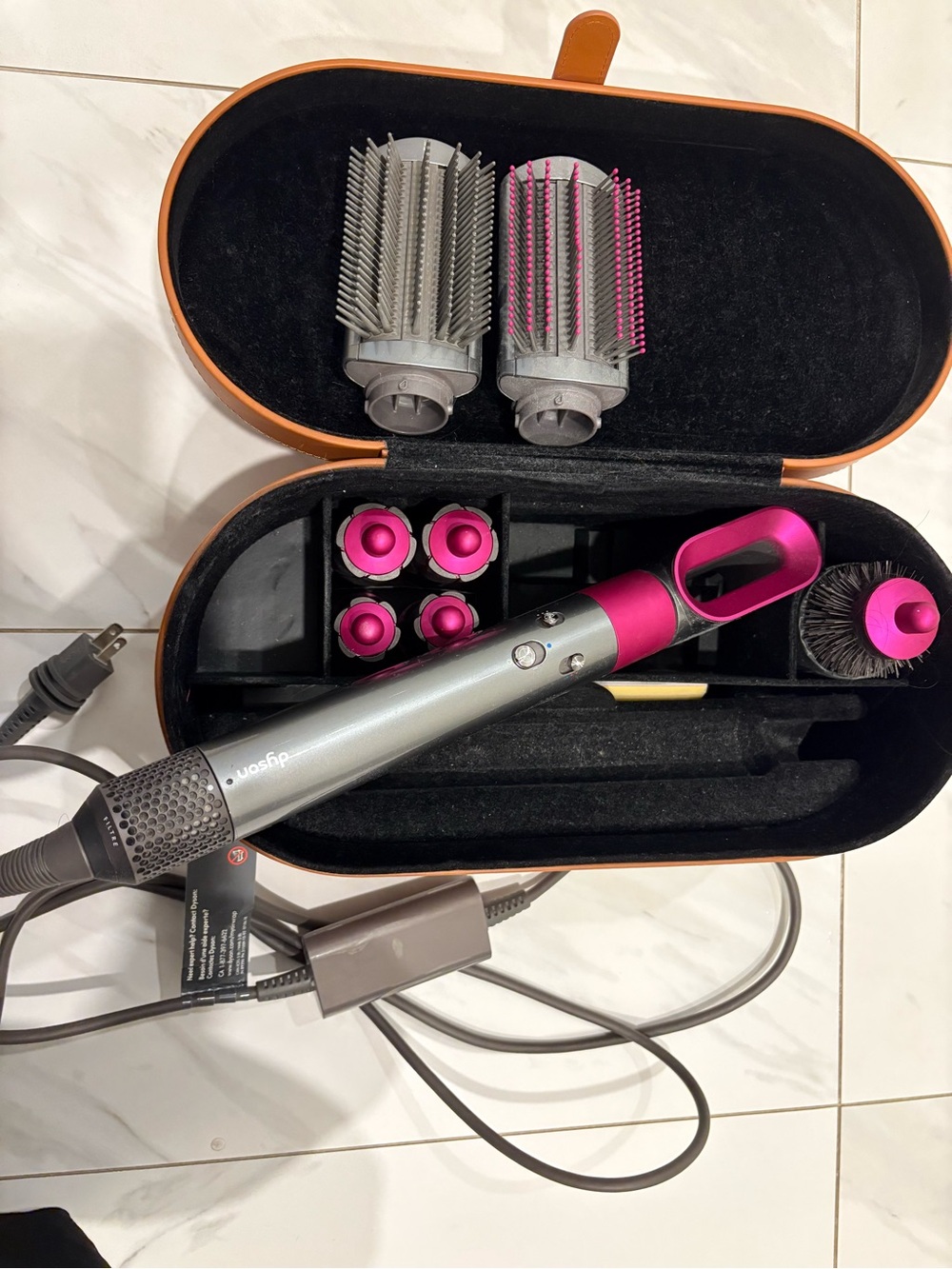 Dyson styler attachments in silver and pink